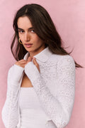 White eyelet active jacket with zip front, raised collar, and long sleeve detail