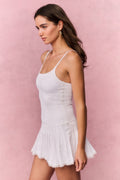 True white eyelet mini dress with spaghetti straps and layered ruffle hem