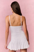 True white eyelet mini dress with racerback straps and tiered hem