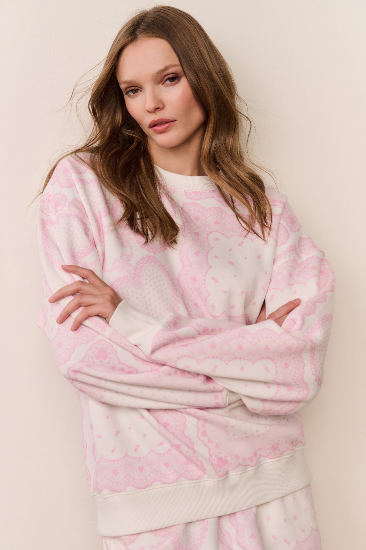 Pink heart-print fleece pullover close-up, long sleeves, crew neck