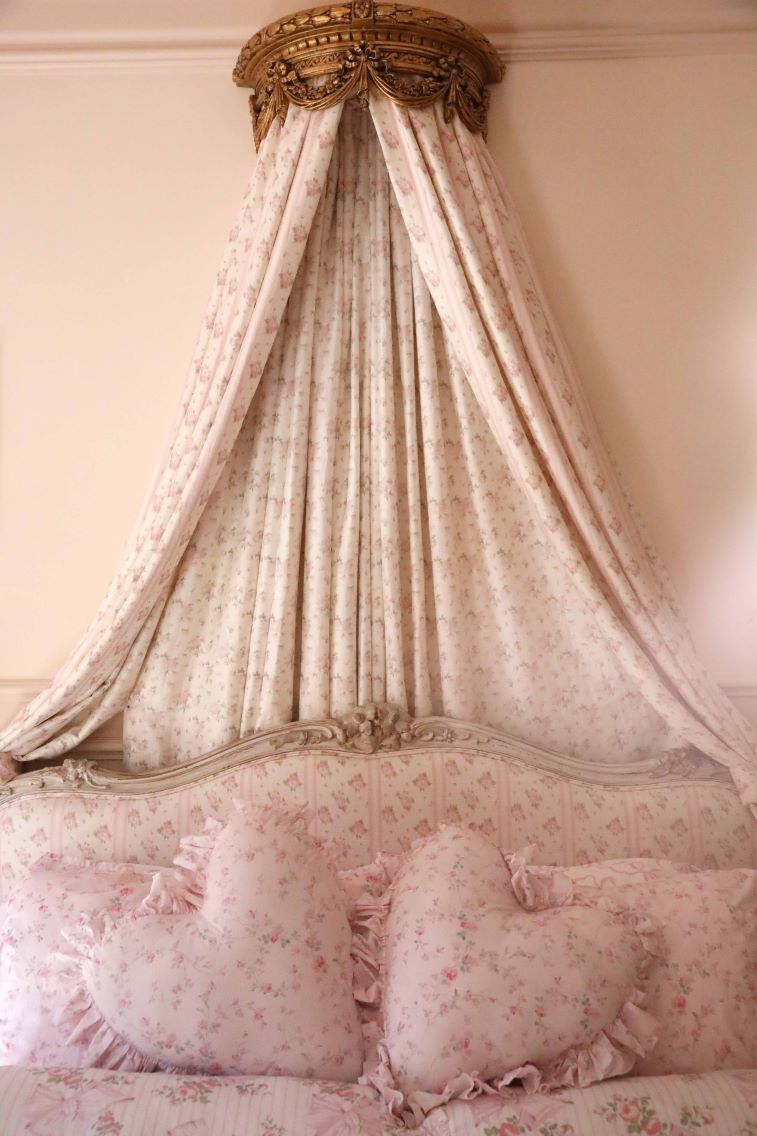Heart-shaped ruffle pillow with pale pink floral print and gathered ruffle edges