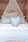 White pointelle throw blanket with delicate blue floral pattern