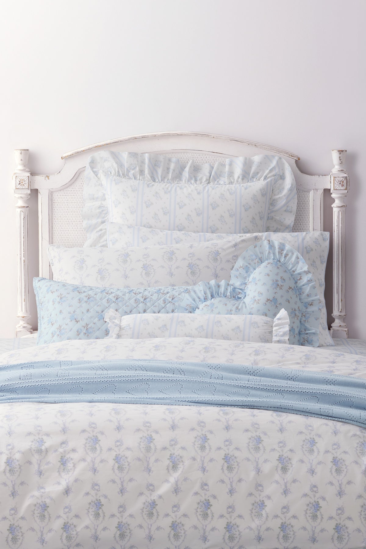 Blue floral ruffle bolster pillow with gathered frill ends