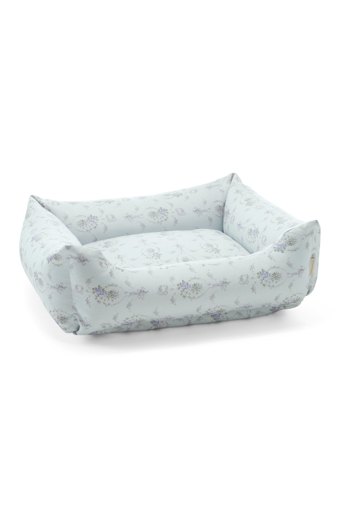 Printed dog bed with light blue floral fabric and low bolstered sides