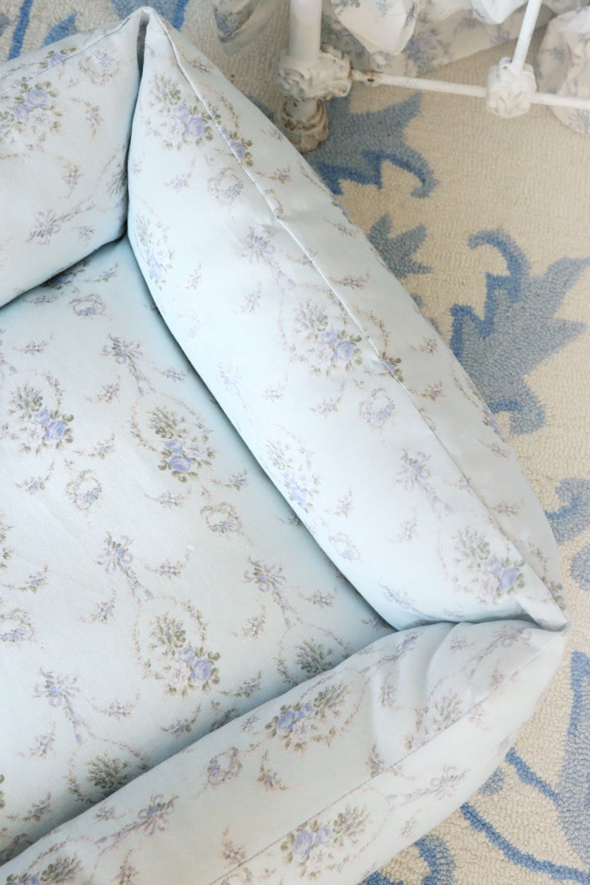 Printed dog bed inner bolster detail in light blue floral print with rounded edges
