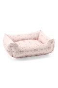 Printed dog bed with blush pink floral fabric and low bolstered sides