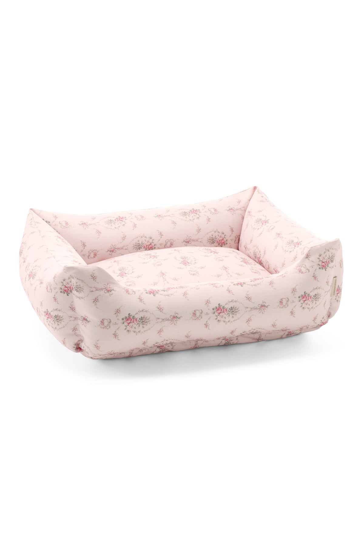 Printed dog bed with blush pink floral fabric and low bolstered sides