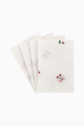 Stack of white embroidered napkins with small red and green motifs