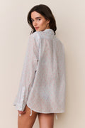 Unisex floral cotton shirt in light blue, long sleeve back view with curved hem