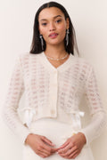 Light cream knit bow cardigan, button-front V-neck with patterned texture and bow ties