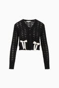 Black bow knit cardigan with V-neck, button front, long sleeves, and white ribbon appliques