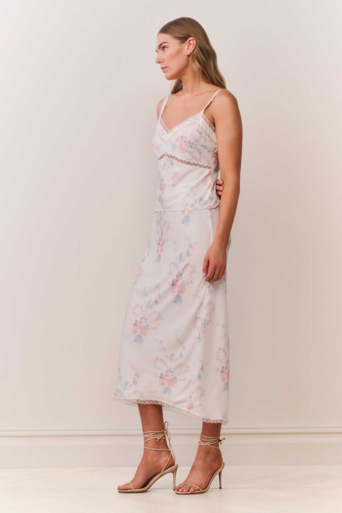 Floral print slip skirt in light pastel tones, lace-trim hem