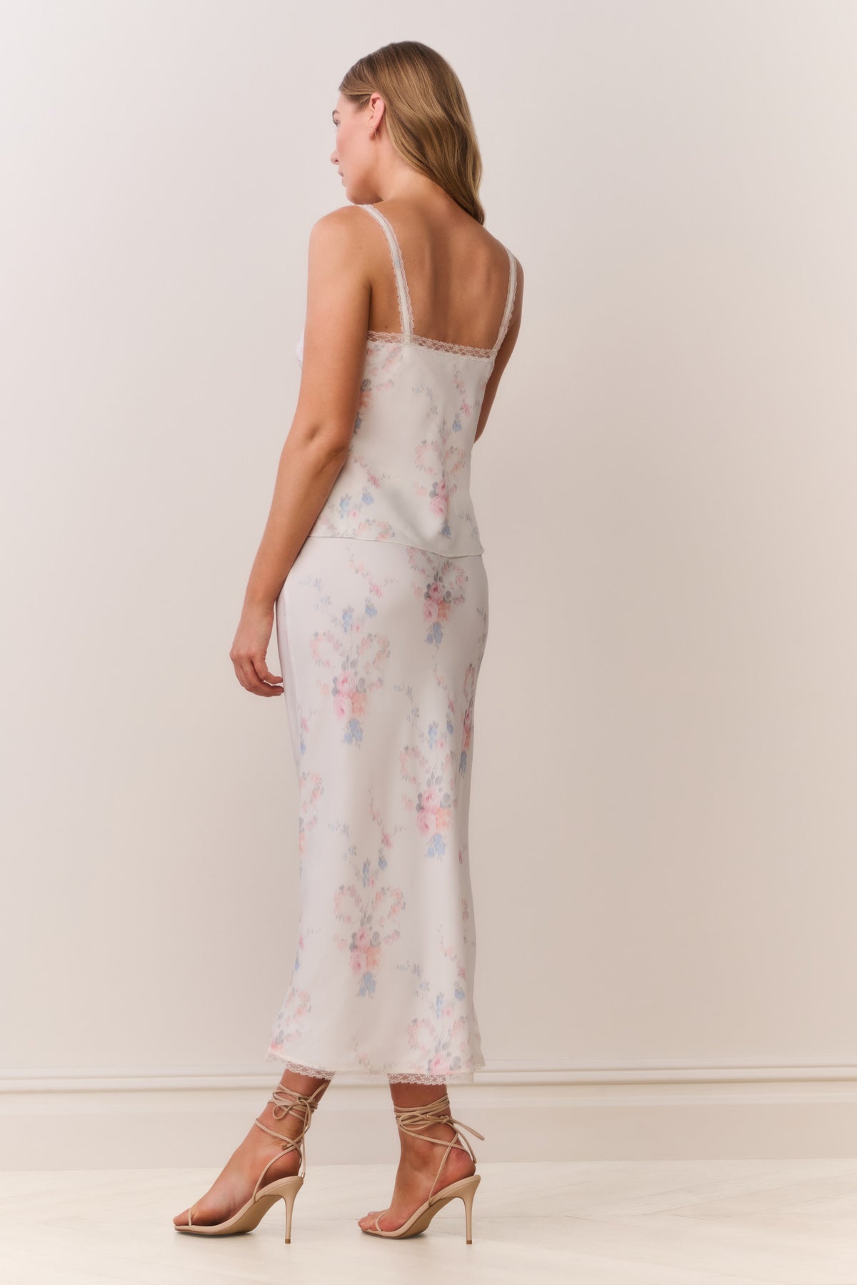 Floral print slip skirt shown from back, with lace-trim hem