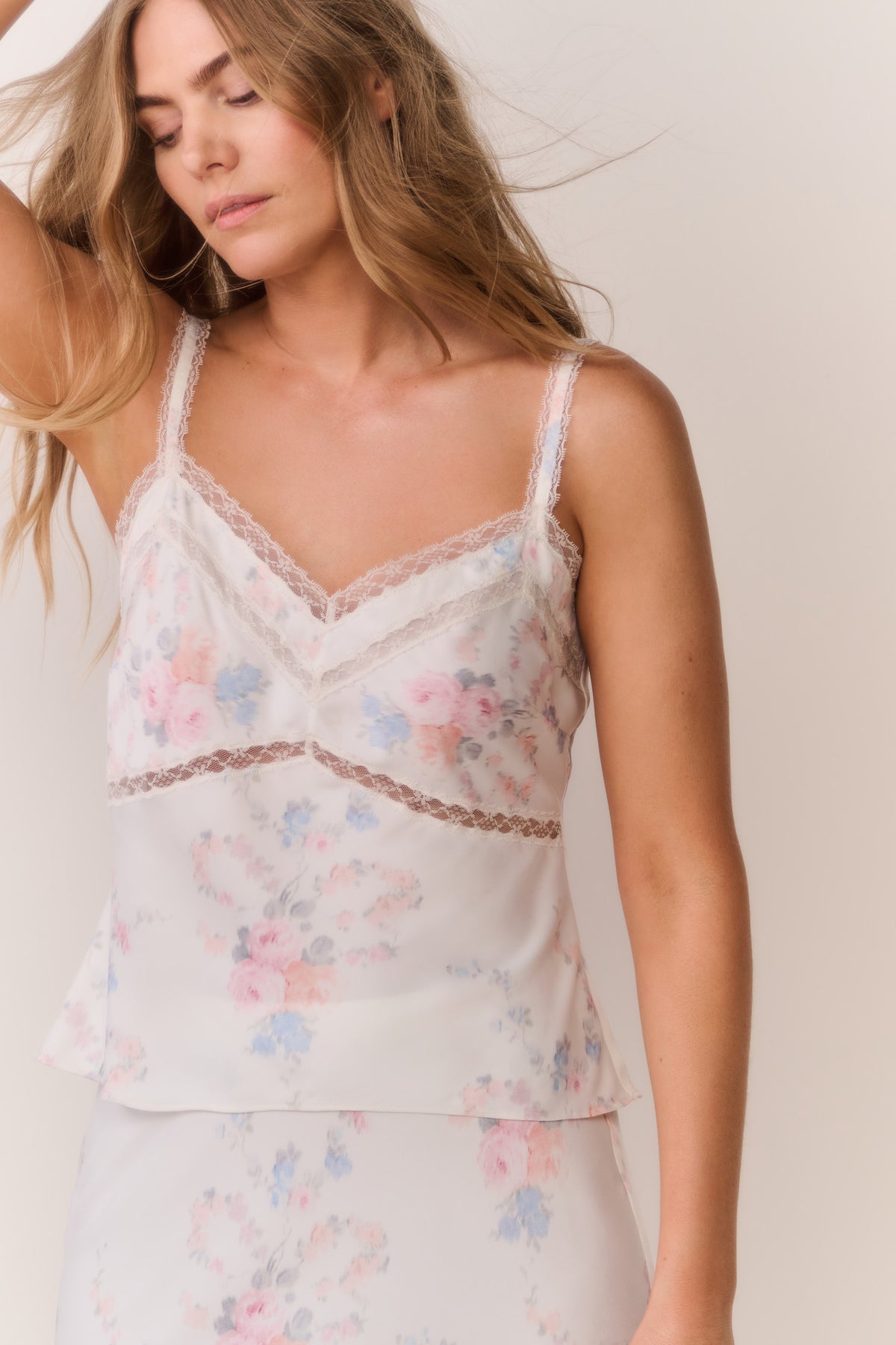 Floral lace-trim cami top with V-neck and thin straps, layered peplum-style hem
