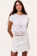 Optic white eyelet mini skirt with allover embroidery and scalloped hem