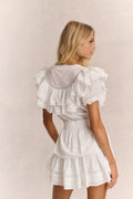 Antique white ruffled cotton mini dress with layered back ruffles and tiered hem