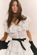 Antique white ruffled cotton mini dress with V-neck, tiered skirt, black waist belt