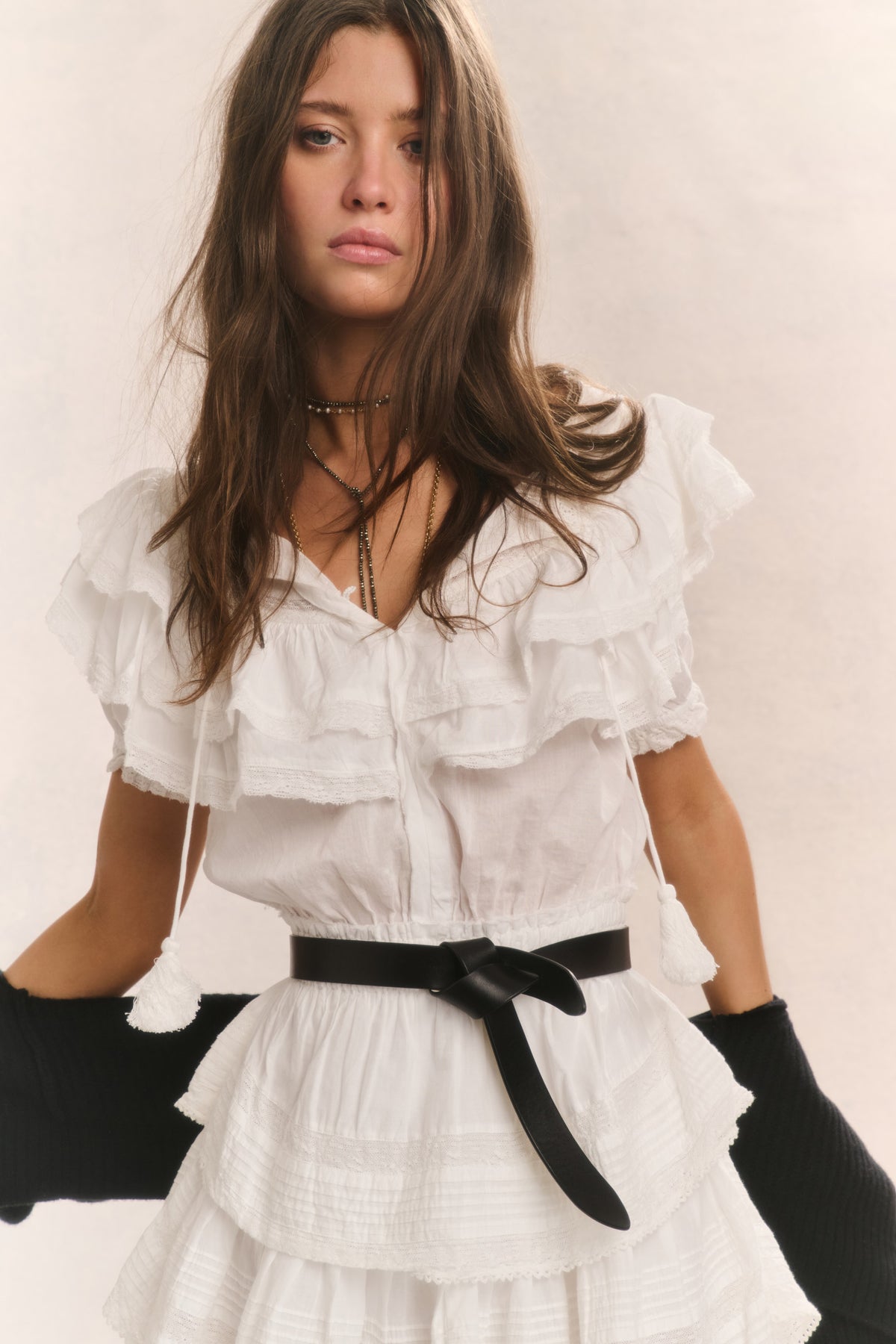 Antique white ruffled cotton mini dress with V-neck, tiered skirt, black waist belt