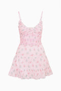 Pink floral cotton mini dress with spaghetti straps and tiered ruffle skirt, flat lay