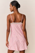 Back view of pink floral print mini slip dress with thin spaghetti straps