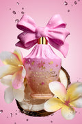 Pink decorative perfume bottle with oversized pink bow and floral label