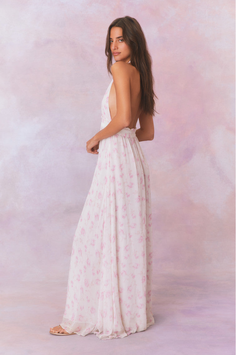 White floral halter maxi dress, standing side view with gathered skirt tiers