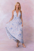 Light blue floral halter maxi dress with flowing, draped skirt and strappy neckline