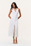 White linen halter maxi dress with V neckline, front buttons, and center slit.
