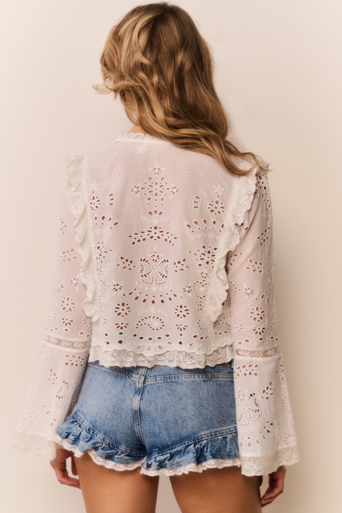 White cotton eyelet blouse with scalloped ruffle collar and button front, long sleeves