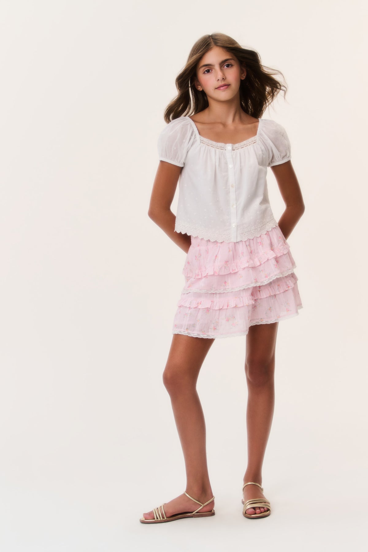 Pink tiered ruffle mini skirt with ditsy floral pattern and elastic waist
