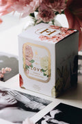 White candle gift box with decorative floral label and Love text