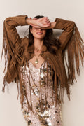 Tan suede fringe jacket with long fringe at shoulders and arms, buttoned closure.