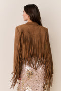 Tan suede fringe jacket back view with long vertical fringe lines and pointed collar.