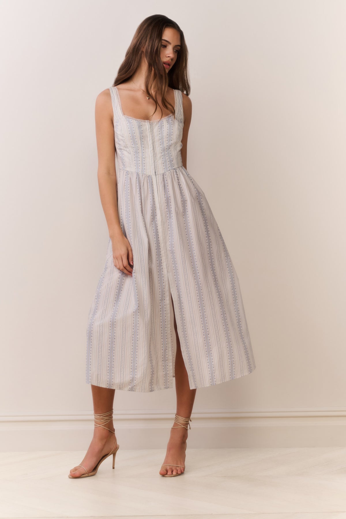 Light blue pinstripe midi dress with bustier bodice, thin straps, and front slit