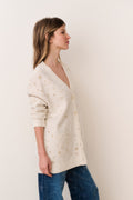 Cream jacquard wool cardigan with gold star pattern, V-neck front view