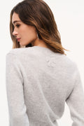 Back view of light heather gray fitted cashmere pullover with small bow detail