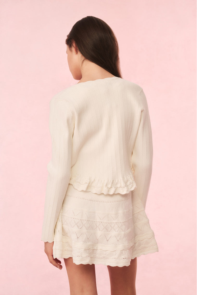 Ivory knit peplum cardigan back view with long sleeves and scalloped hem