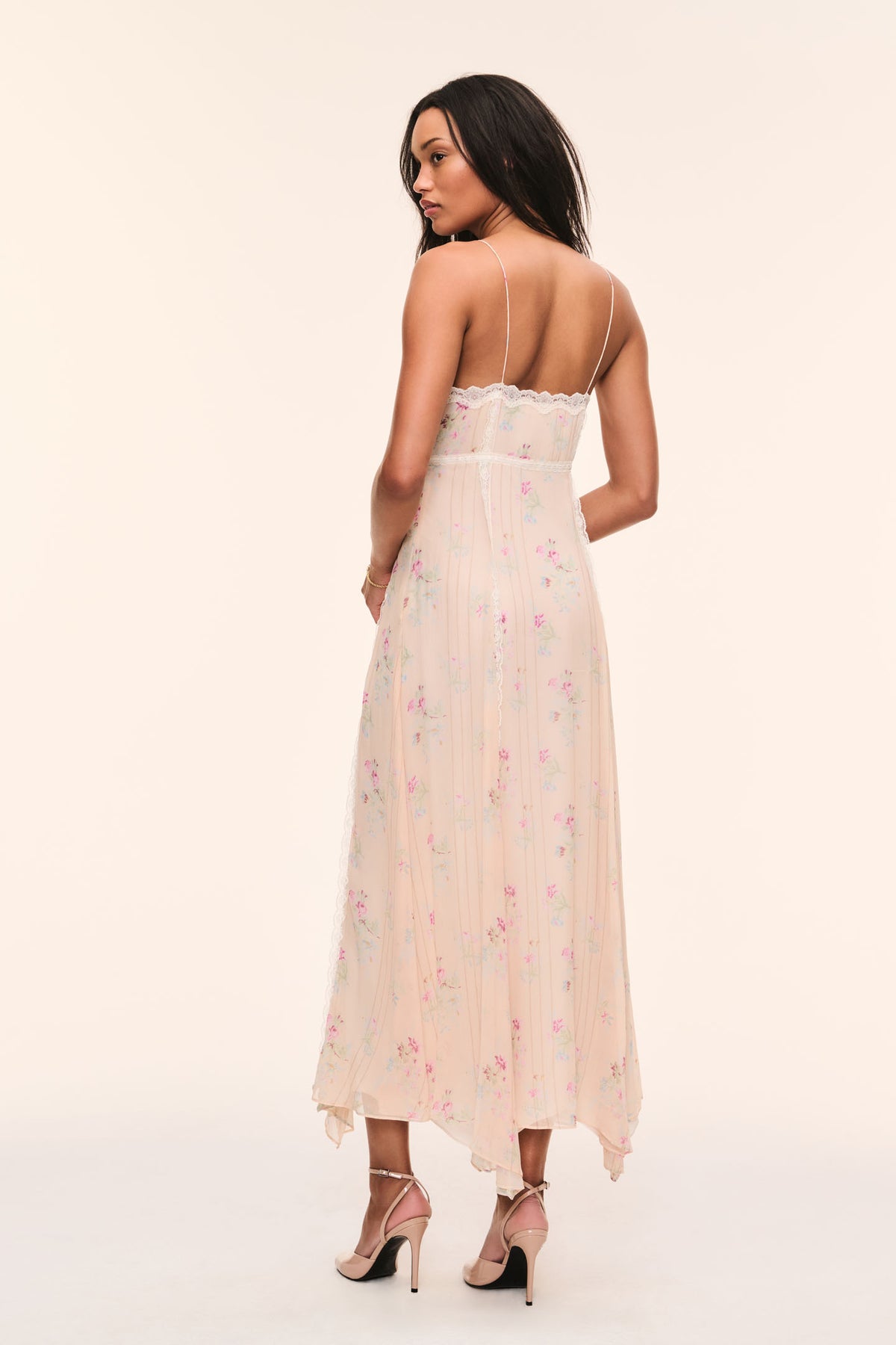Back view of floral print silk slip dress with lace-trim straps and open back