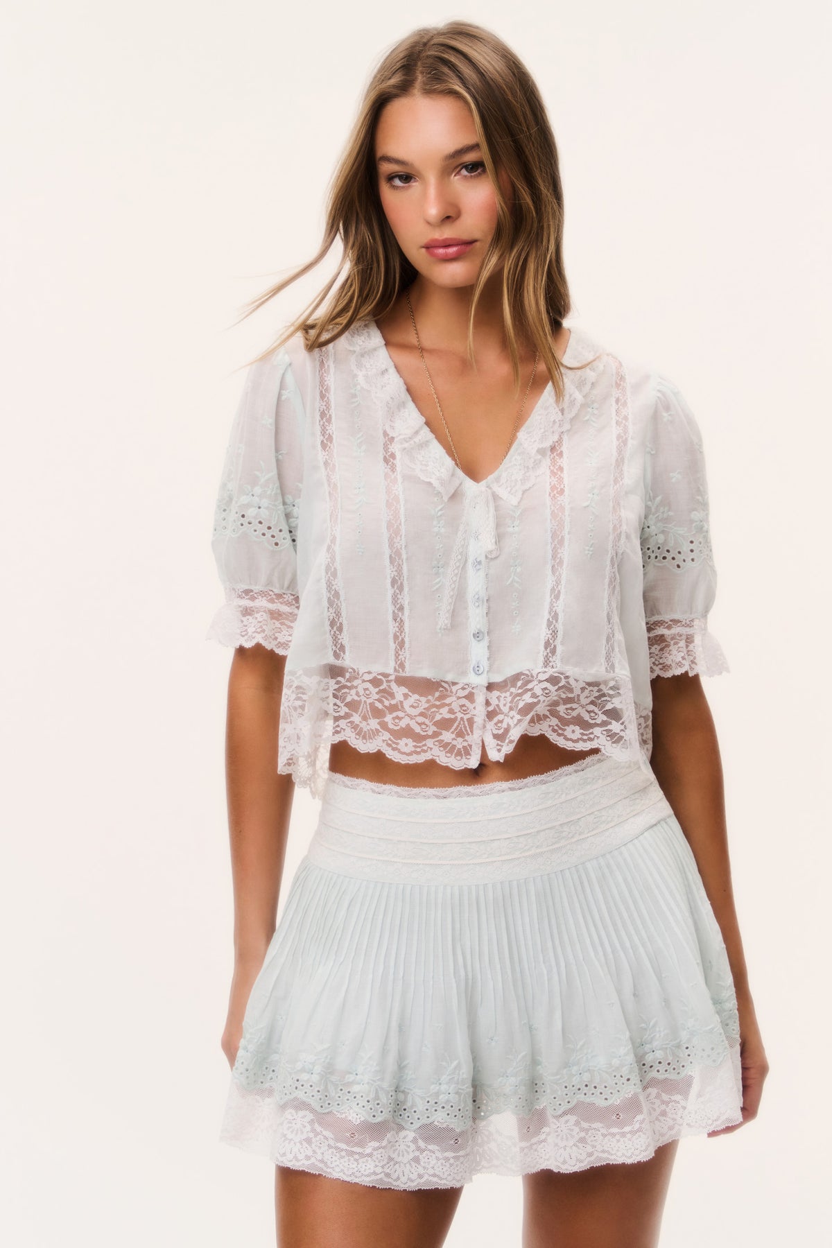 Ivory lace-trim mini skirt with pleated tiers and elastic waistband