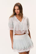 Ivory mini skirt with lace-trimmed tiered ruffles and smocked elastic waist