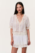 Ivory mini skirt with lace-trim hem and tiered, smocked waistband