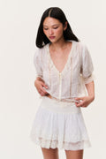 Ivory tiered mini skirt with lace trim and detailed lace panels