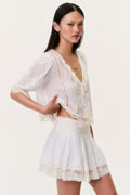 Ivory lace-trim mini skirt with gathered tiers and elasticized waist