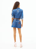 Medium-wash denim mini skirt from back view with button waist and embroidered yoke