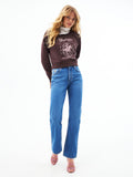 Medium wash cowboy cut jeans with straight waistband, zip fly, and flared hem