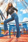 Medium wash cowboy cut jeans with flared leg and embroidered back pocket stitching