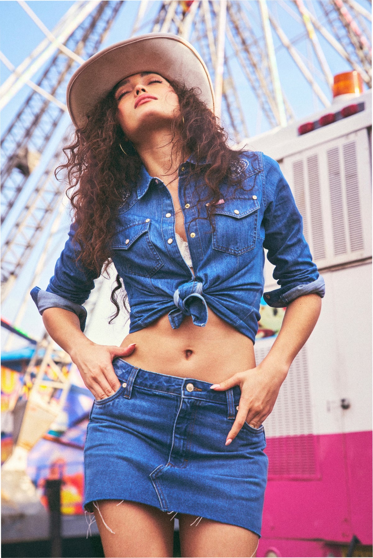 Medium-wash denim mini skirt with raw hem, button front, and front patch pockets
