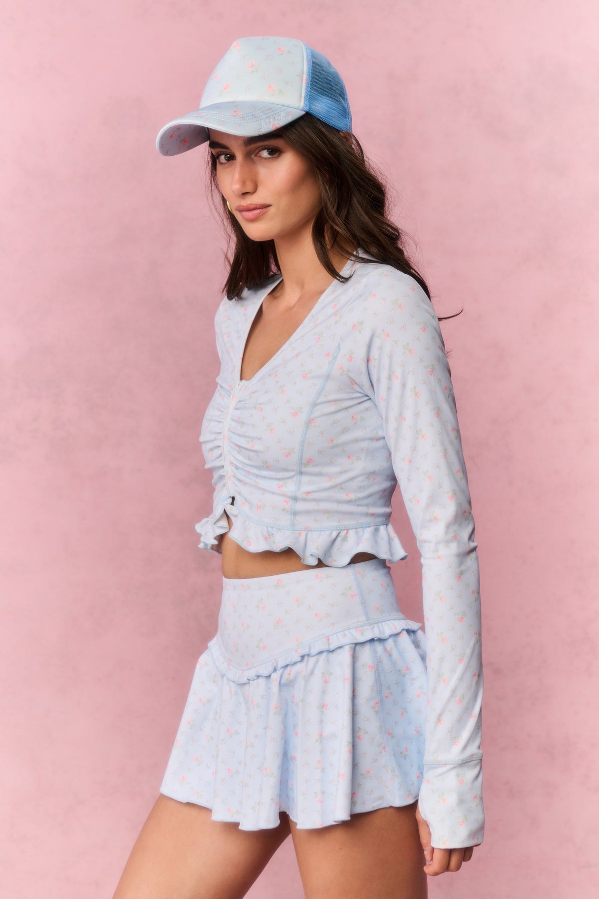 Light blue printed zip-up active top with V-neck, long sleeves, and ruffle peplum hem