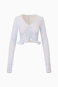 Light blue printed zip-up active top with long sleeves, V-neck, and ruffled hem