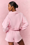 Pink fleece polo sweatshirt, back view with stand collar and ribbed hem